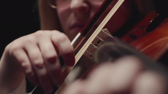 In Studio a Closeup Woman Plays Violin