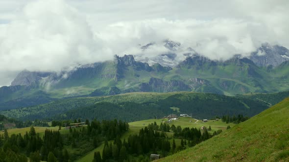 Clouds rolling above mountain landscape, Alta Badia, Italy