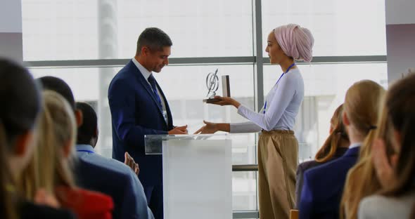 Businessman receiving award from businesswoman in the business seminar 4k
