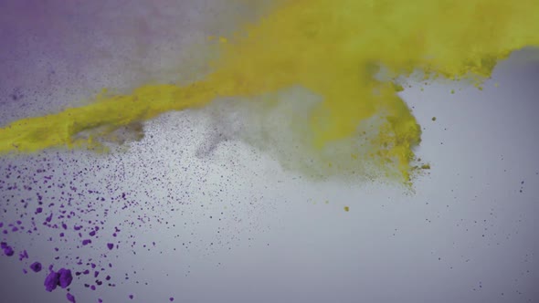 Purple and yellow powder colliding in the air, Slow Motion