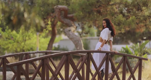 Woman in Elegant Summer Dress Outdoors in the Park Outdoors