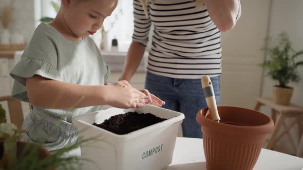 Video of mother and daughter preparing compost. Shot with RED helium camera in 8K