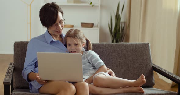 Happy Parent Mother and Cute Small Child Daughter Two People Looking at Laptop Screen Webcam Having