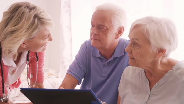 Female Doctor Consulting to a Senior Couple