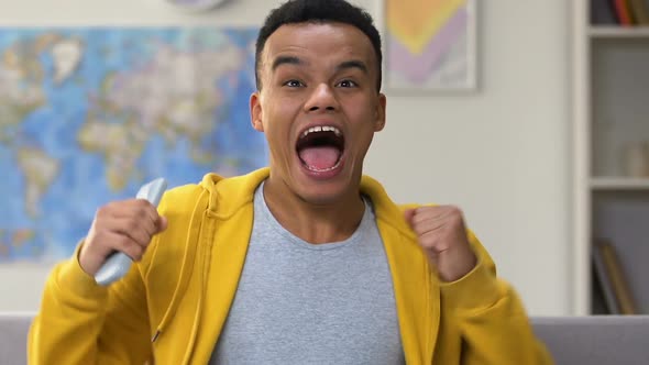 Happy Afro American Boy Cheering for Favorite Team Winning Sports Match on Tv