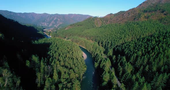 Low Altitude Flight Over Fresh Fast Mountain River with Rocks at Sunny Summer Morning