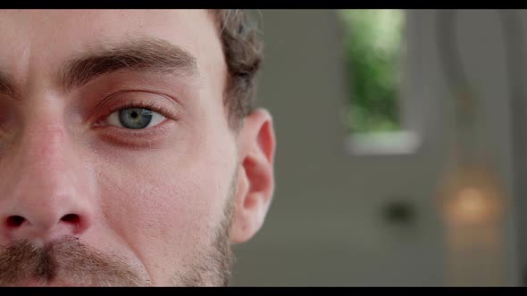 Closeup Half Face Portrait of a Smiling Attractive Man with a Stubble Looking at Camera