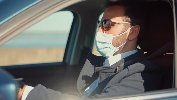 Self Isolation On Car On Covid19 Lockdown Coronavirus Quarantine.Driver Protective Face Mask In Car