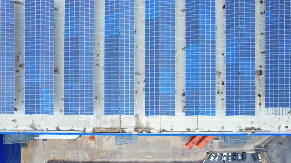 Aerial cinematic view of a solar panel on mall roof top