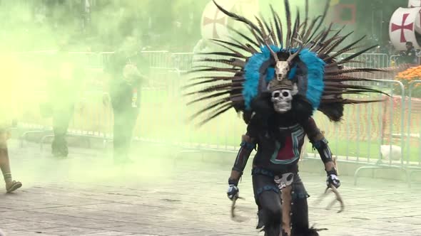 medium shot, pre hispanic character performing during day of the dead parade in Mexico city