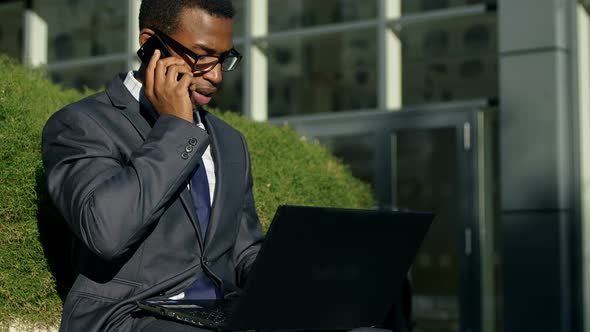 Businessman - african american - working with laptop outdoors