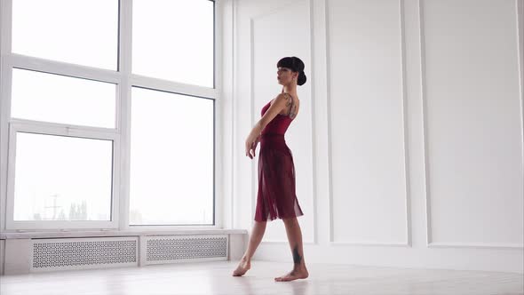 Young Brunette Dancer Is Doing Motions in a Dancing Class in Daytime