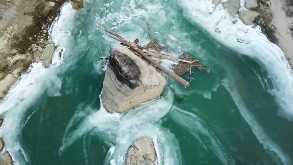 Driftwood Caught on River Boulder