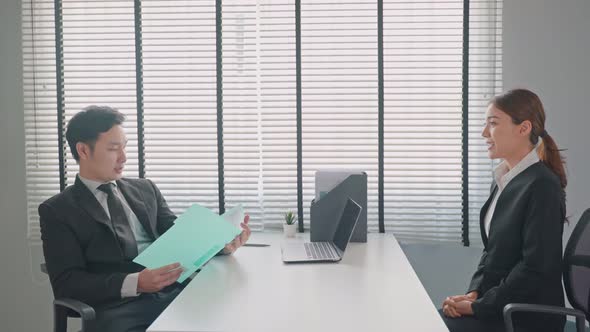 Female employee shake hands with human resources manager businessman after job interview.