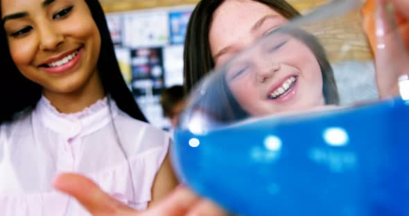 Smiling school kids doing a chemical experiment in laboratory