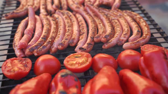 Delicious German Sausages Sizzling Over the Coals on Barbecue Grill