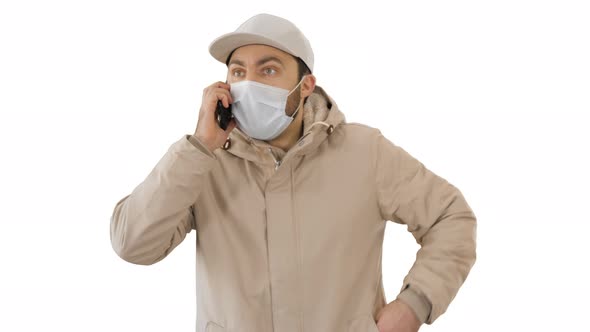 European Young Man Calling with a Medical Mask on His Face on White Background.