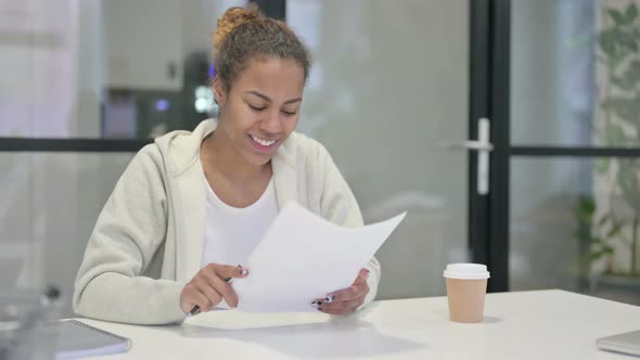 African Woman Having Success While Reading Reports