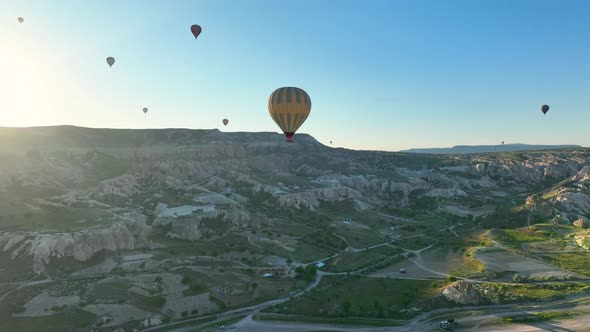 4K Aerial view of Goreme. Colorful hot air balloons fly over the valleys.