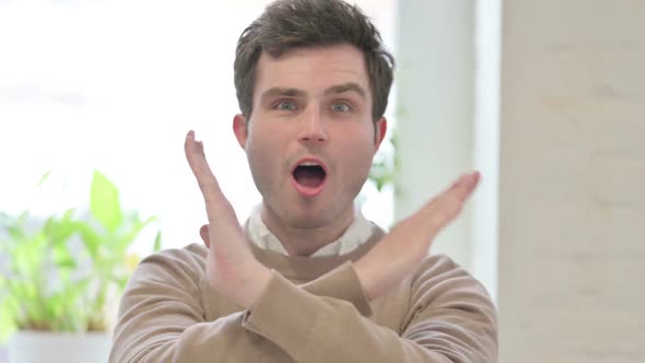 Portrait of Man Showing No Sign By Arm Gesture Denial