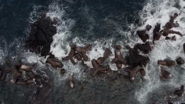 Aerial View of Waves Breaking on Breakwaters