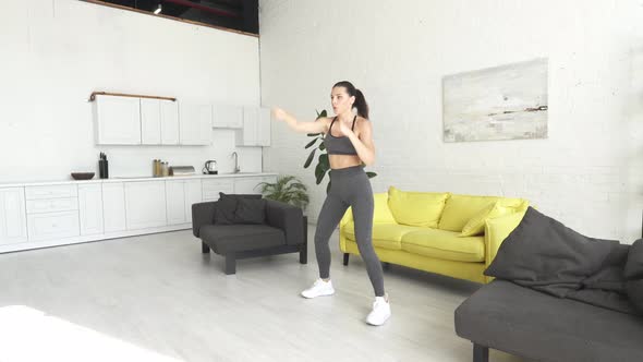 Beautiful Young Woman Doing Fitness at Home