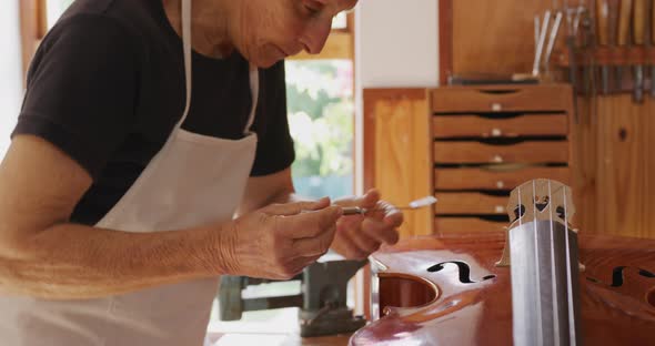 Female luthier at work in her workshop