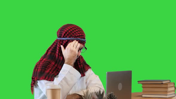 Arab Businessman Surfing in Internet Using His Laptop with Different Emotions on a Green Screen