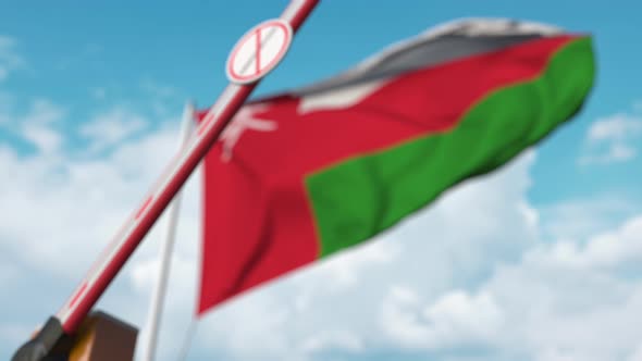 Closing Barrier with Stop Immigration Sign at the Omani Flag alt