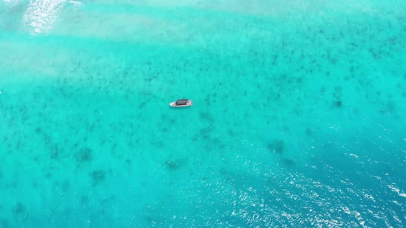 Aerial Top View of a Fishing Boat Sailing in Turquoise Waters of Ocean Zanzibar