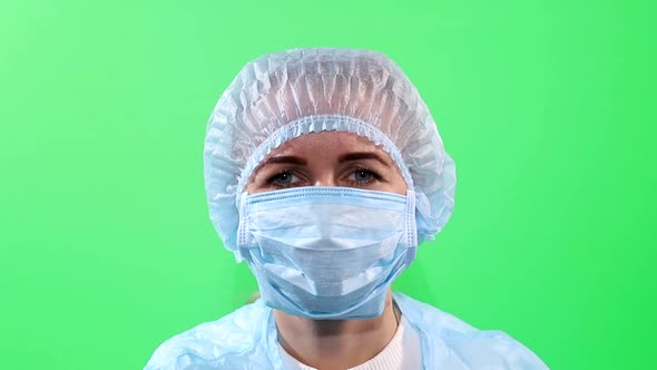 Studio portrait of young woman wearing face mask, close up isolated on chromakey background.