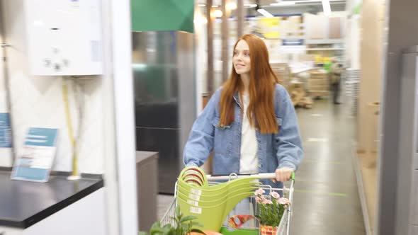Happy Woman in Market Aisle, Looking for Things They Need.