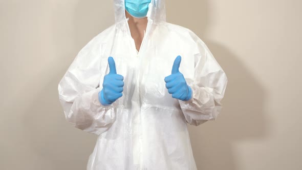 doctor in ppe suit making thumbs up gesture