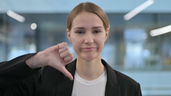 Portrait of Thumbs Down Gesture By Businesswoman