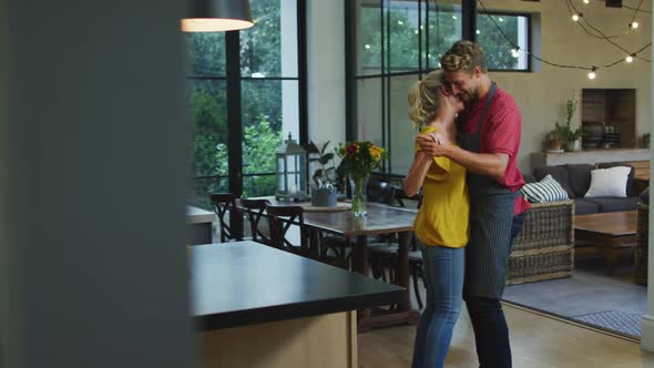 Happy couple dancing in the kitchen