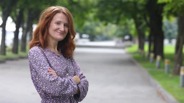 Portrait Of Young Smiling Woman Standing In The Urban Park Alley 2