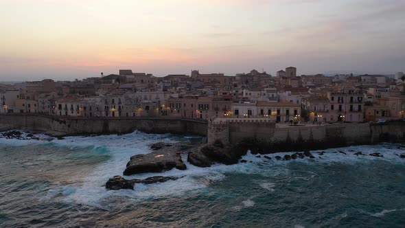 A Bird's Eye View of Ortigia Island at Sunset. Sailing Ship Out of the Bay