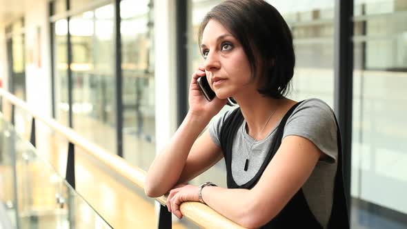 Business female answering phone call in office