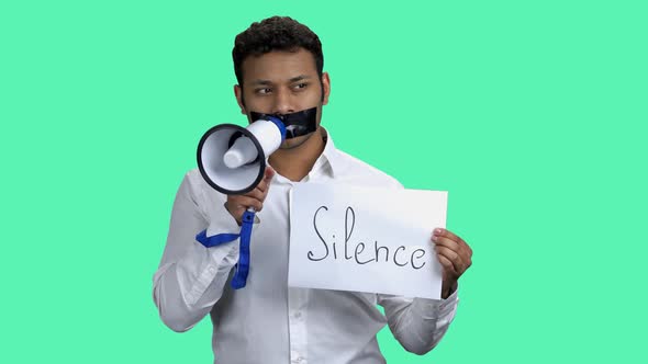 Silenced Man with Megaphone on Color Background