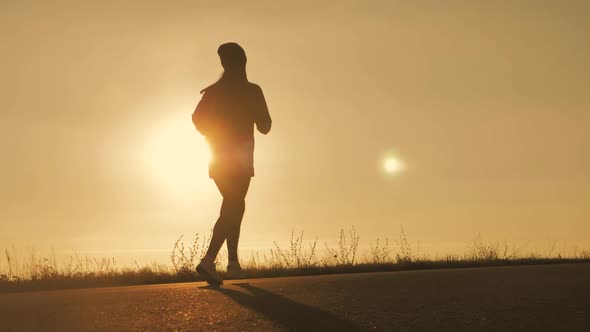 Silhouette Fitness Sport Women Running on Road at Sunset