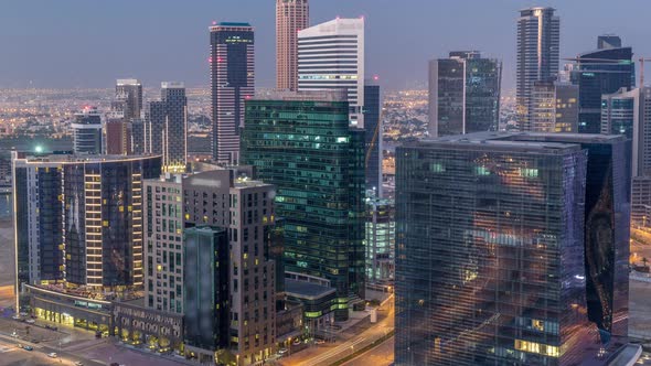 Panorama of Business Bay Dubai Night to Day Aerial Timelapse