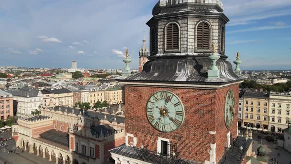 Aerial view of the clock tower in Krakow's main square and St. Mary's church at sunny day. Krakow, P