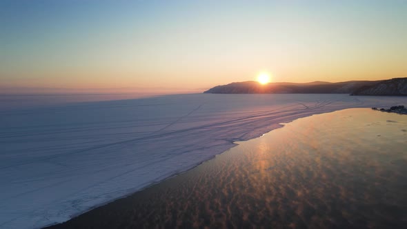 Baikal on an gorgeous delightful colorful sundown. Drone slowly flies over lake