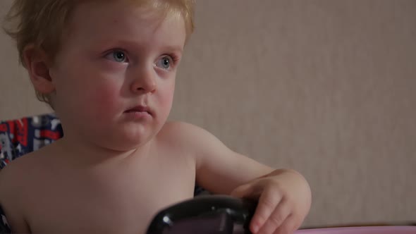 Little Boy With Remote Watching TV alt