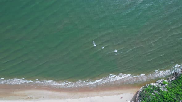 4K Aerial view top view of drone, sea waves and beautiful sand beach.