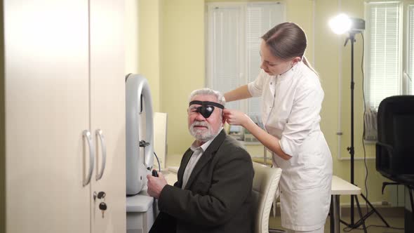 Oculist Examination of Elderly Man on Device Perimeter of Field of View