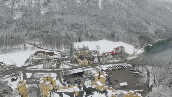 Aerial View Of Hohenschwangau flying backwards over the castle in winter