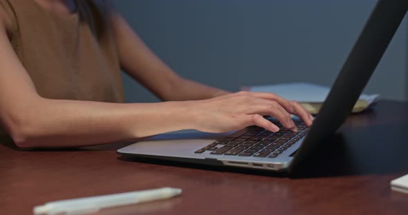 Woman work on computer at home in the evening