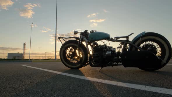 Closeup Dolly Shot of Custom Cafe Racer Motorcycle at Sunset on Street