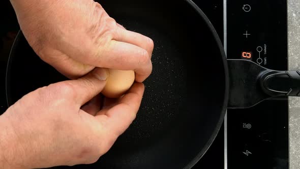 Preparation Fried Eggs in Frying Pan for Breakfast on Electric Stove on Domestic Kitchen